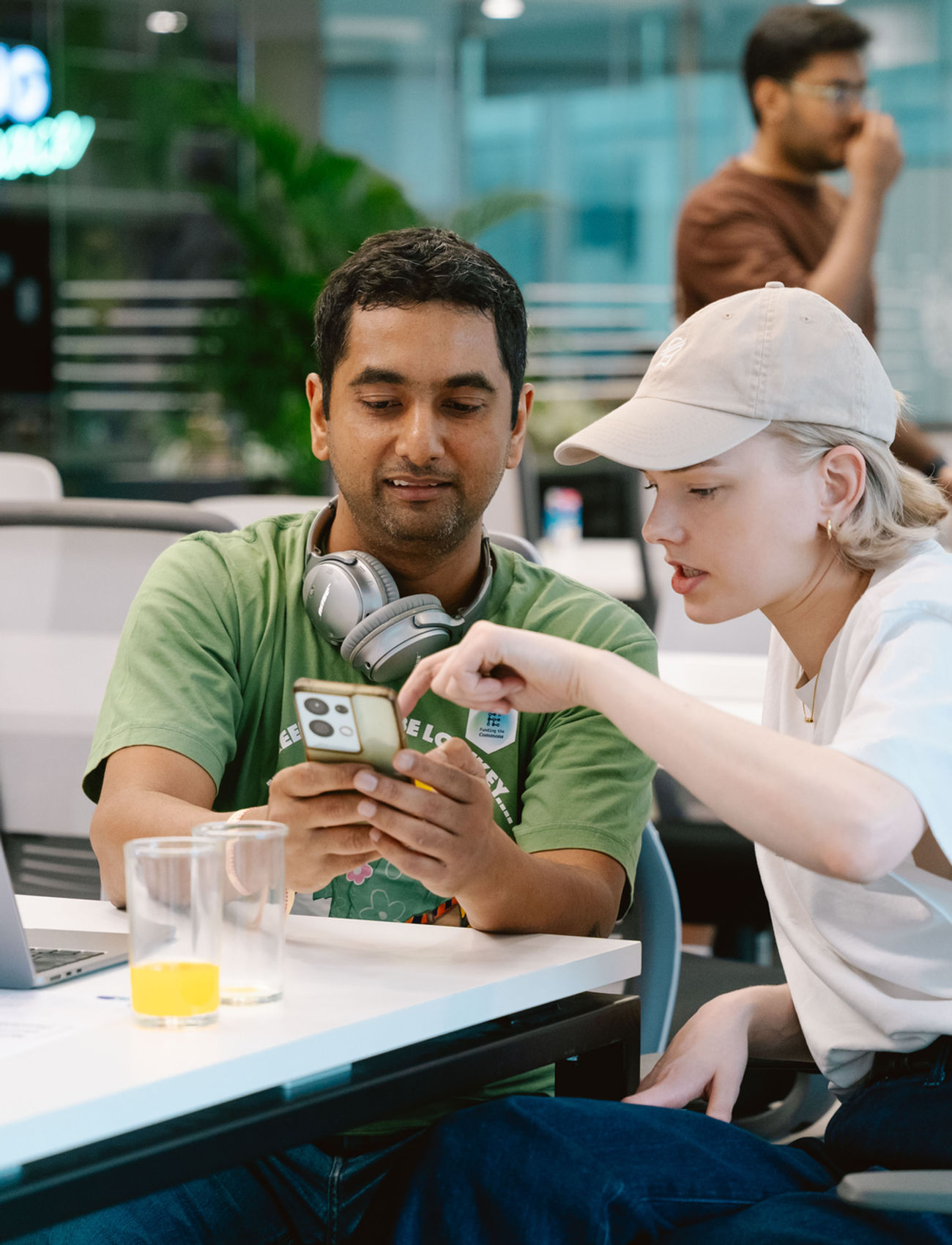 Two Funding the Commons residents working together over a phone