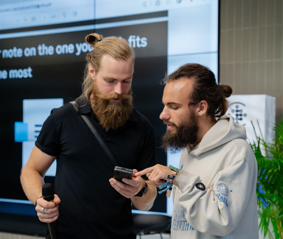 Two builders comparing notes during a working session